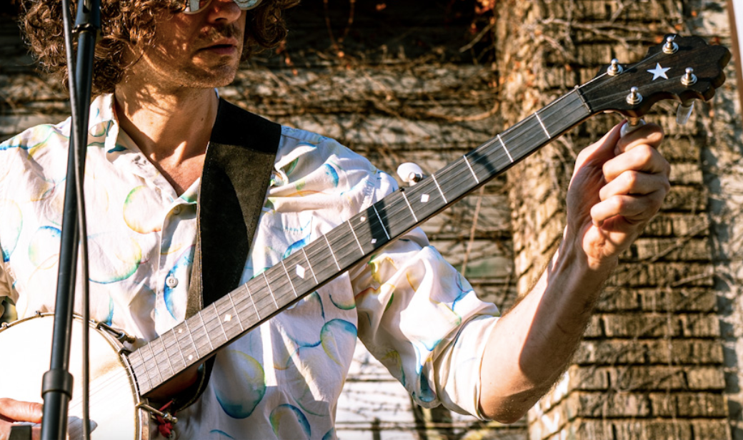 Ben is tuning his banjo